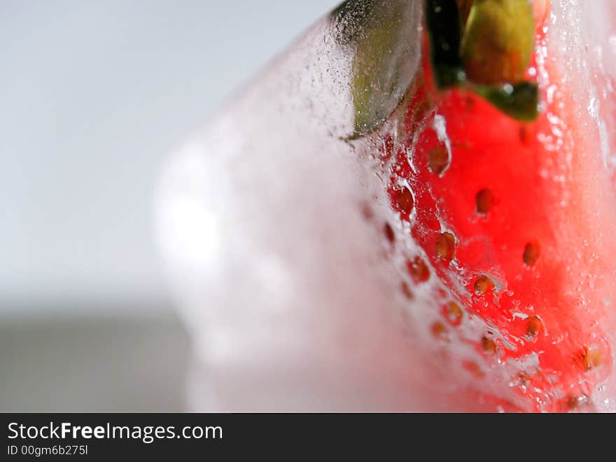 Frozen strawberry in an ice cube. Frozen strawberry in an ice cube