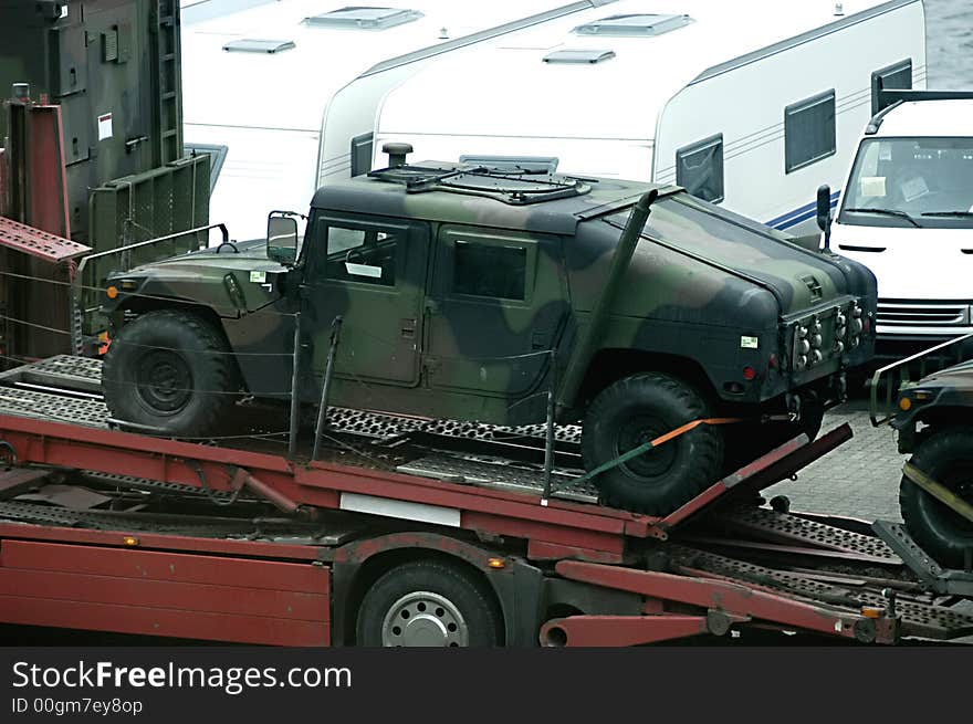 Picture of military truck - Hummer loaded on truck to transport in Kiel port, Germany.