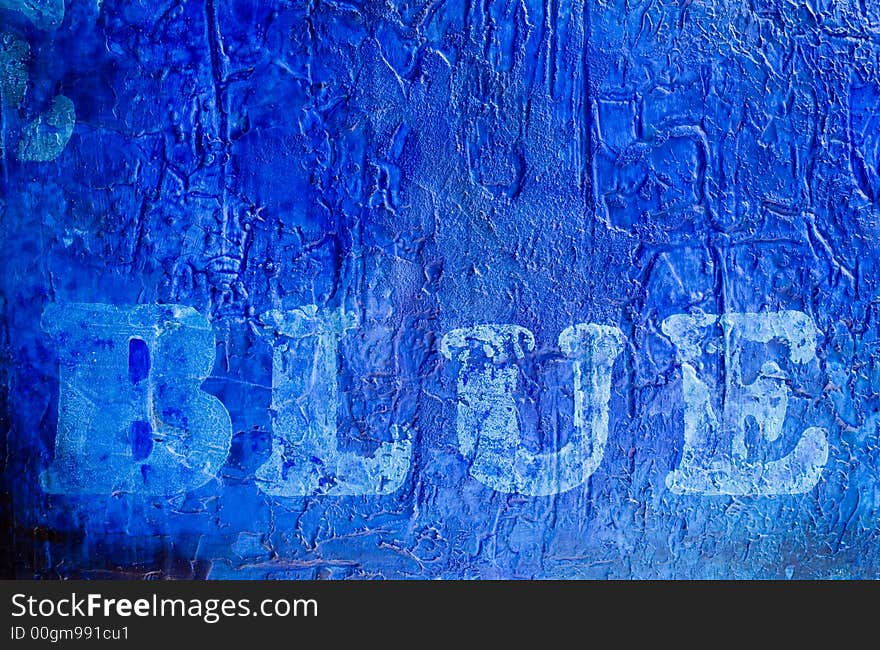 Word blue printed on abstract blue painting, painting was created by photographer