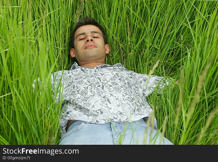 Boy relaxing in high grass