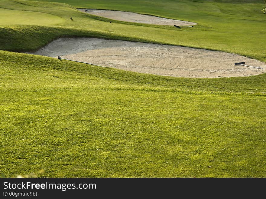 A nice green field for the game of golf. A nice green field for the game of golf