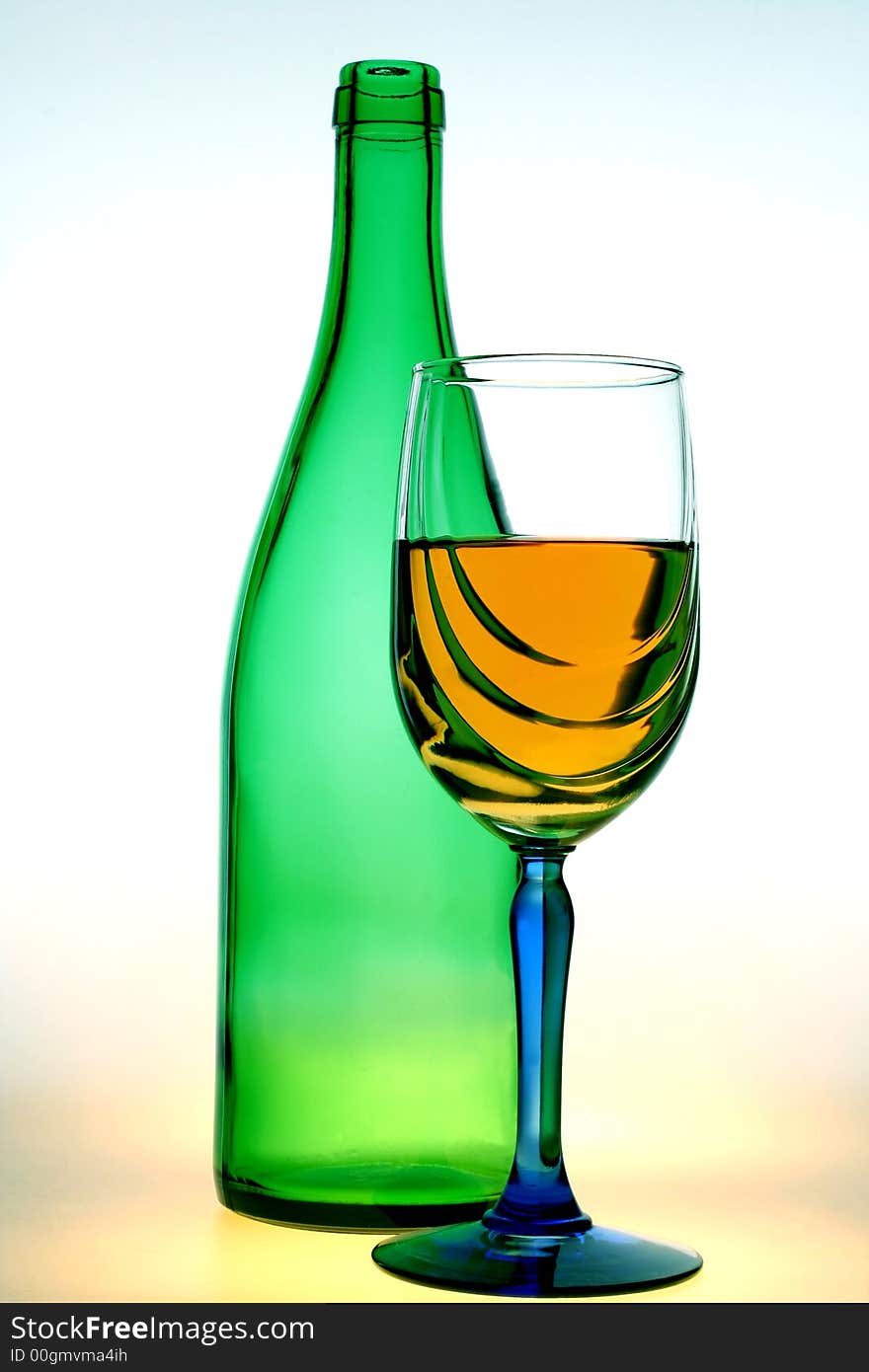 Green bottle and a glass of wine on a white background. Green bottle and a glass of wine on a white background.