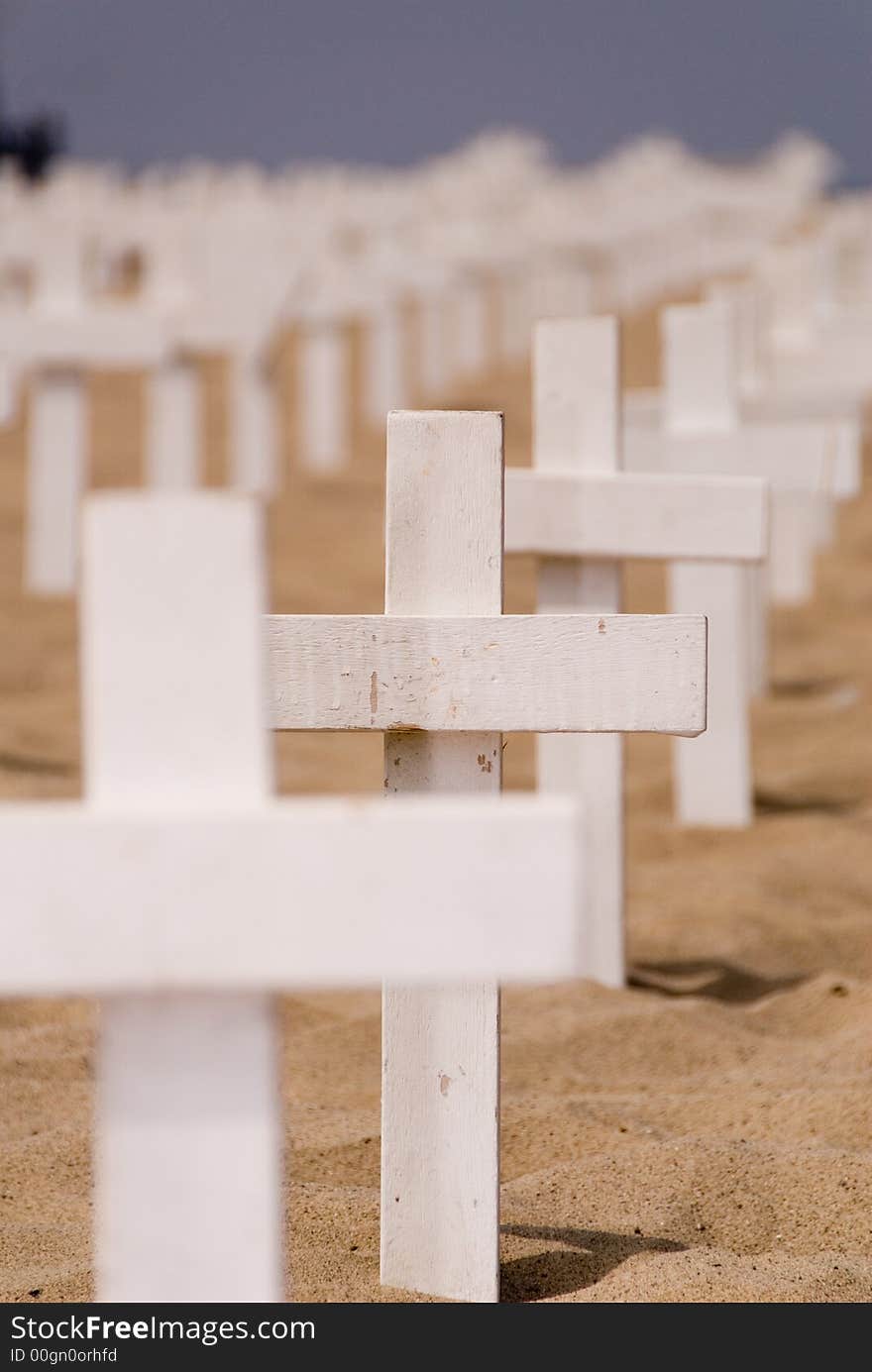 2nd cross in focus while the rest are blurred and in rows on the beach. 2nd cross in focus while the rest are blurred and in rows on the beach.