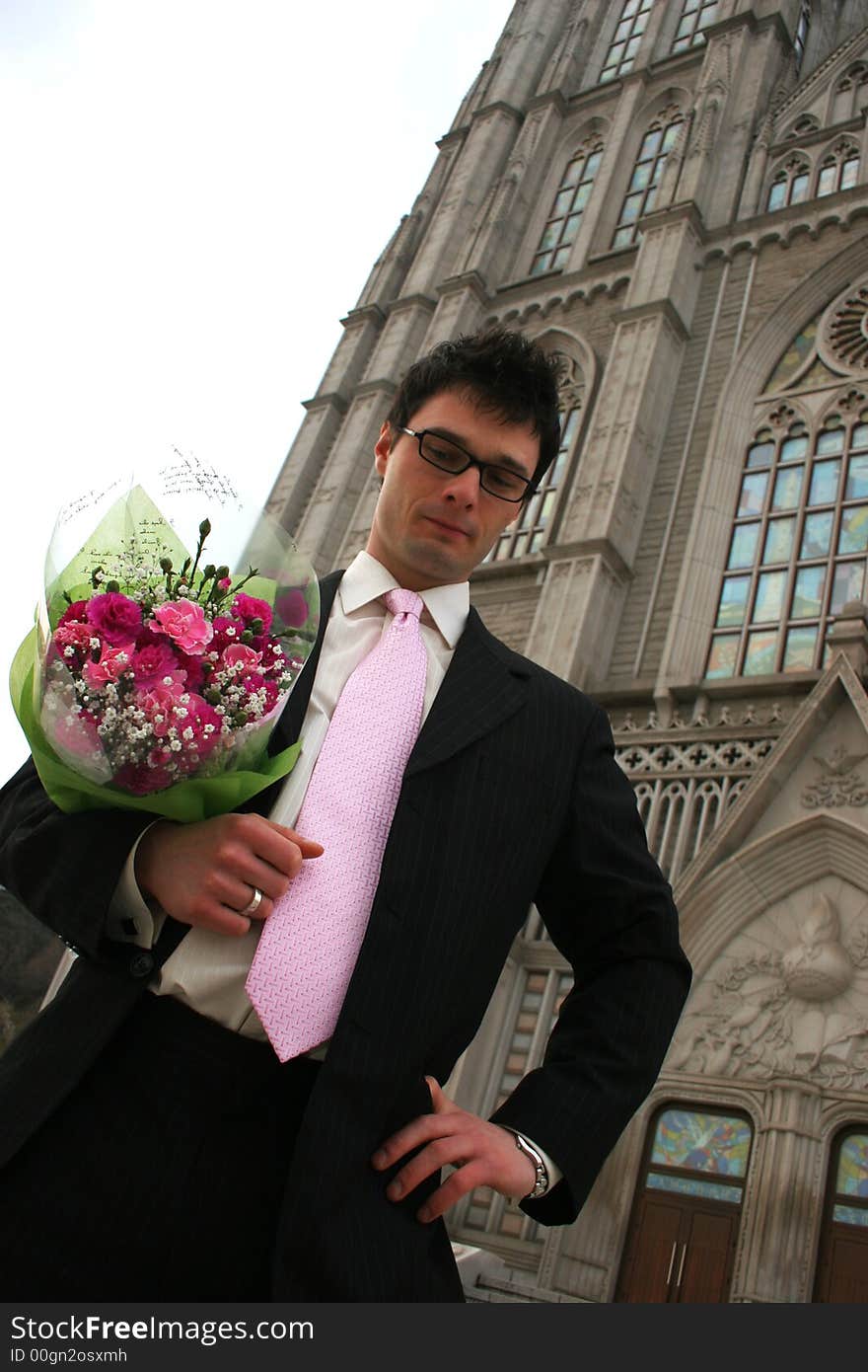 Nervous groom waiting for his bride at church.