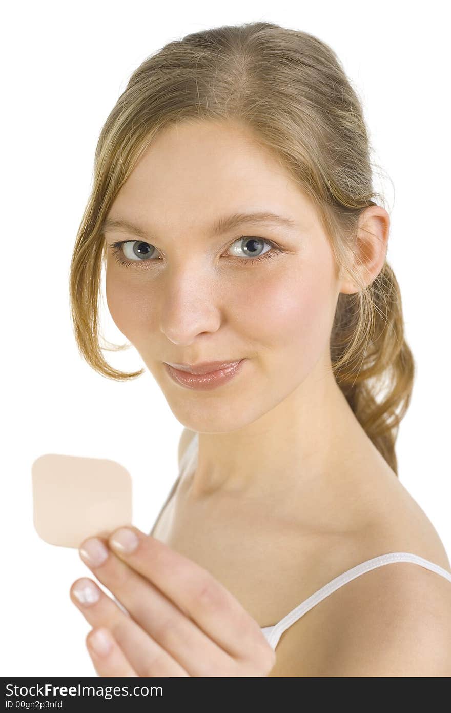 Young smiling woman holding and showing contraception patch. Looking at camera. Young smiling woman holding and showing contraception patch. Looking at camera