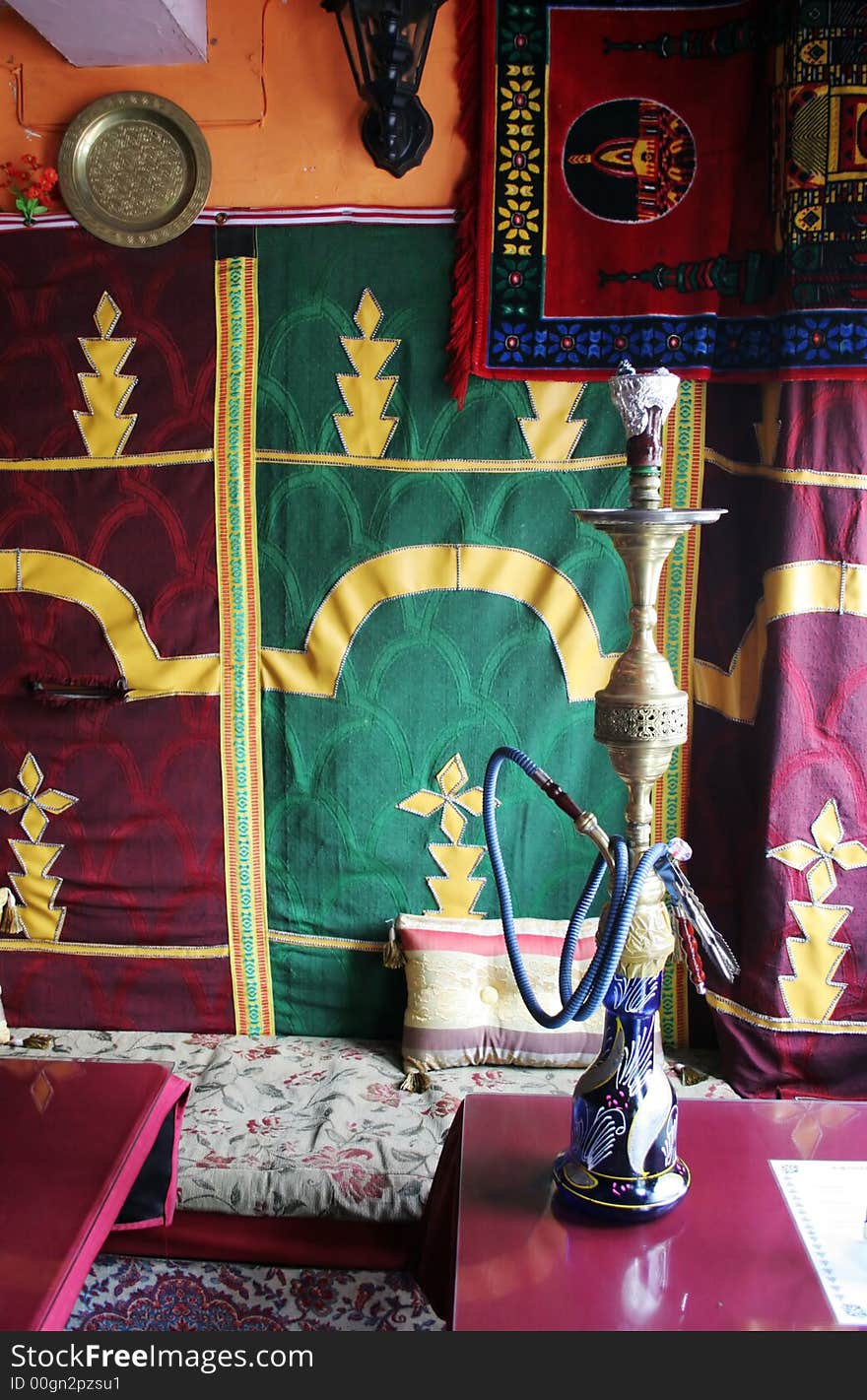 Interior of a Moroccan restaurant with a glass of water on the table - travel and tourism. Interior of a Moroccan restaurant with a glass of water on the table - travel and tourism.