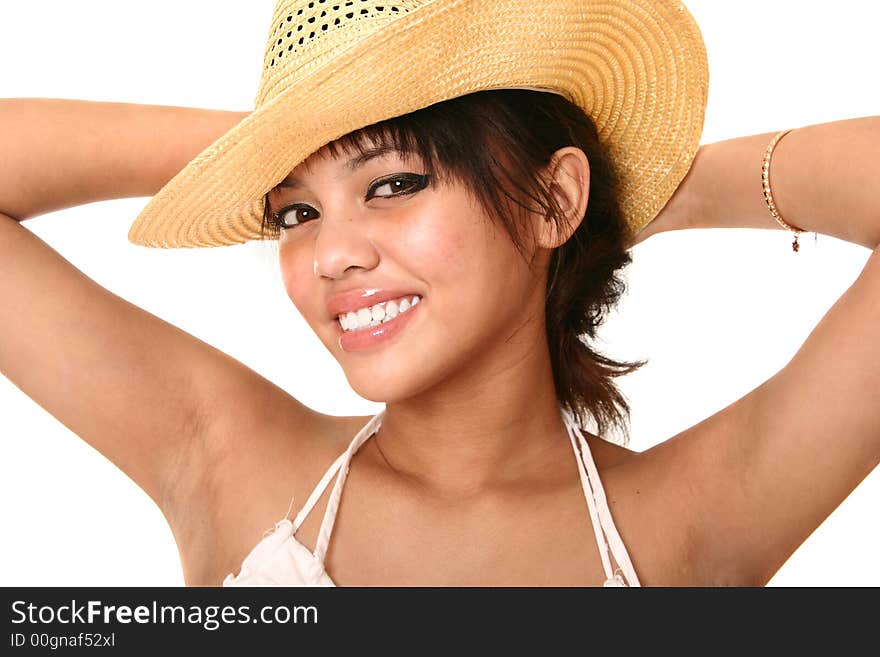 Beautiful brunette wearing straw hat with her hand on her back. isolated on white