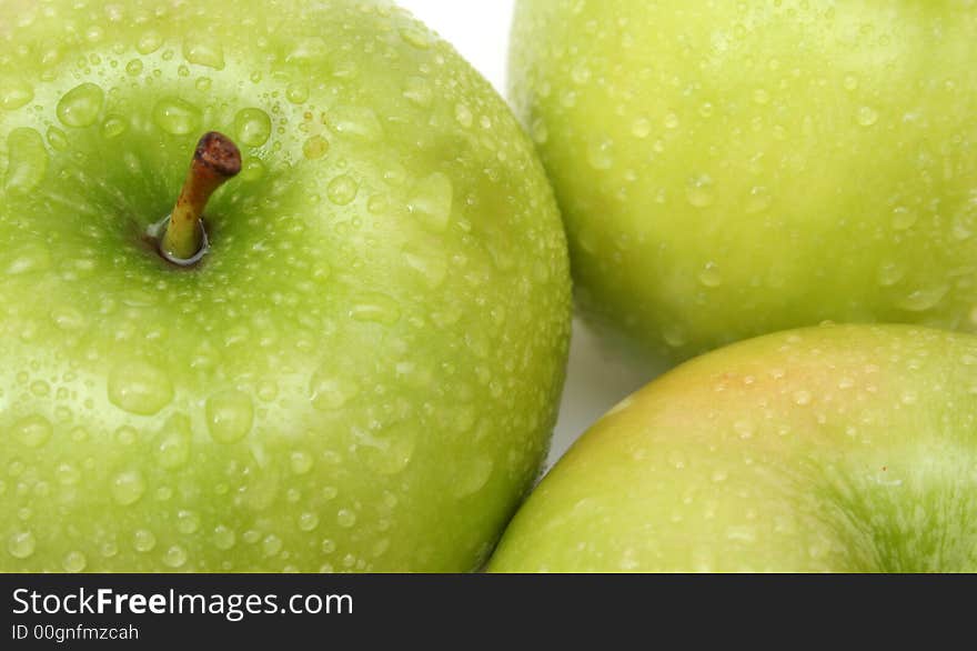 Green wet apples' background over white. Green wet apples' background over white