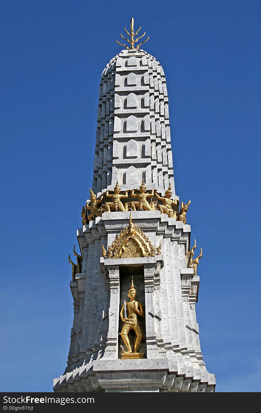 Golden statues on a stone monument in Wat Pho, Bangkok