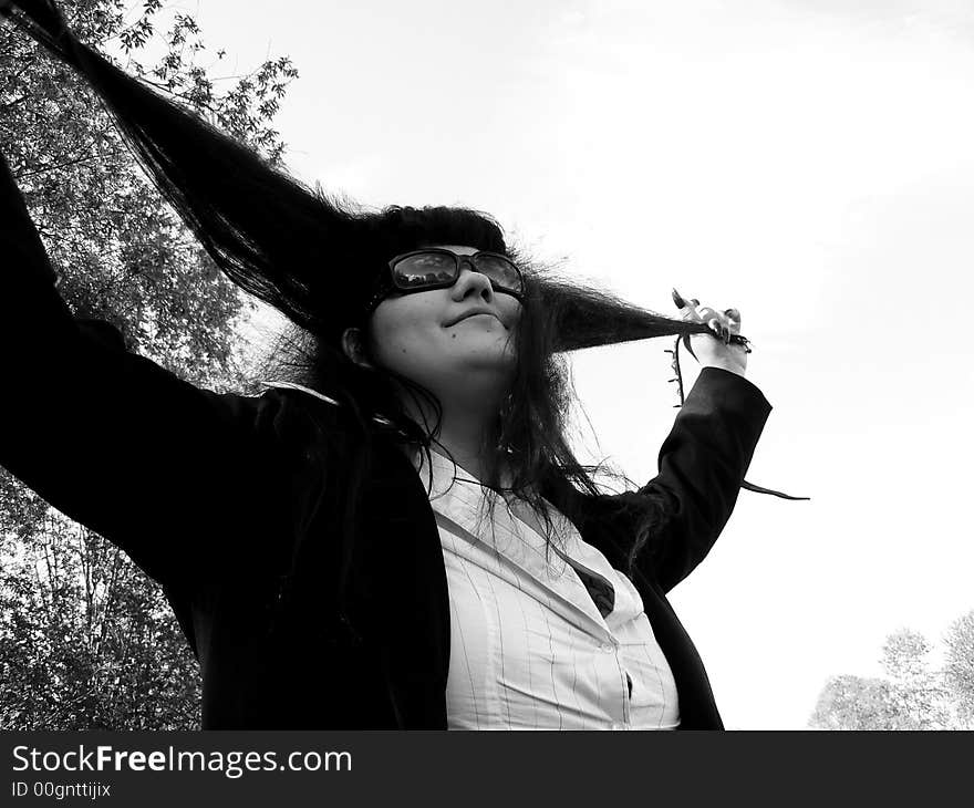 The woman stretches hair on a background of the river. The woman stretches hair on a background of the river