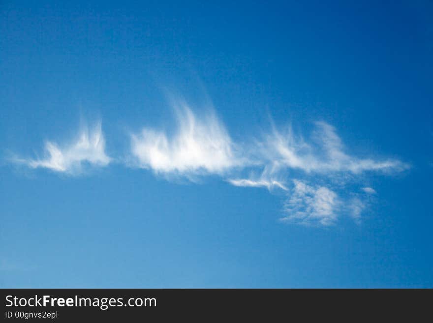 Feather-like clouds in the blue sky. Feather-like clouds in the blue sky