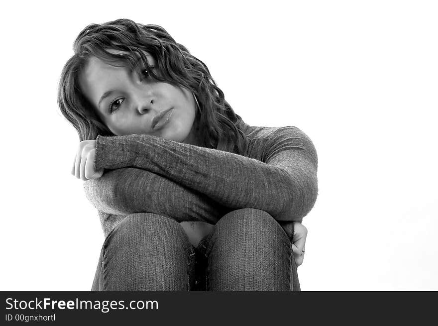 Woman with head on knees, in B&W, with long sleeve top