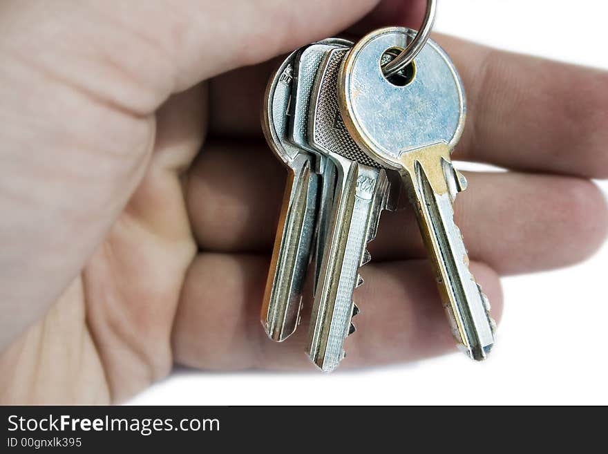 Hand holding keys,isolated on white.