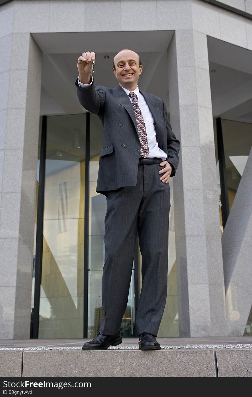 Businessman offering the keys to your future in his hands. Businessman offering the keys to your future in his hands