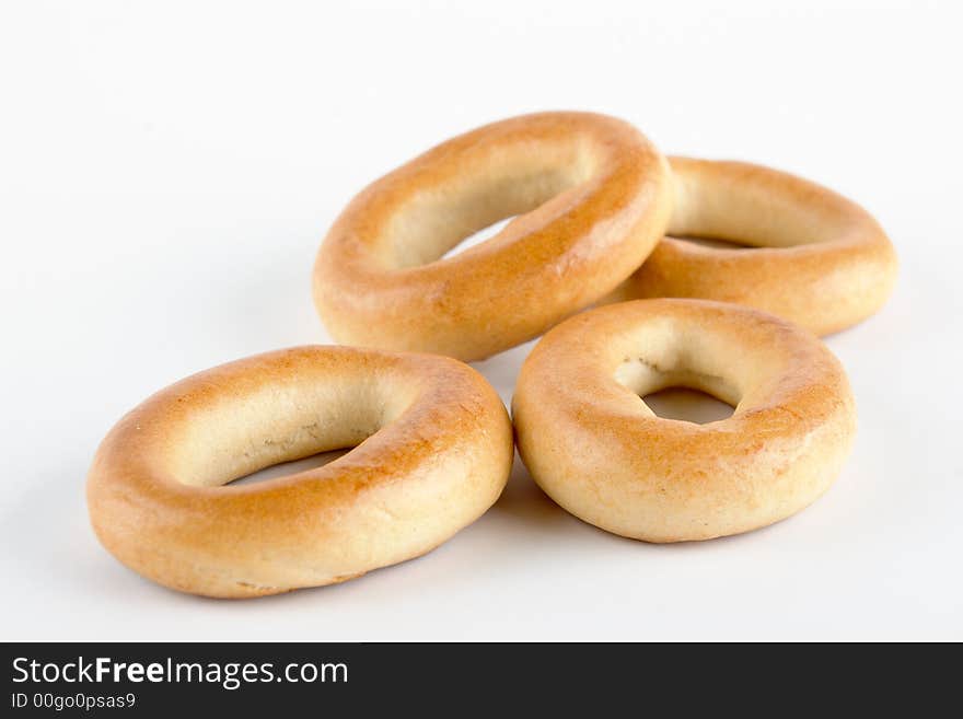 Heap of small bagels on white background