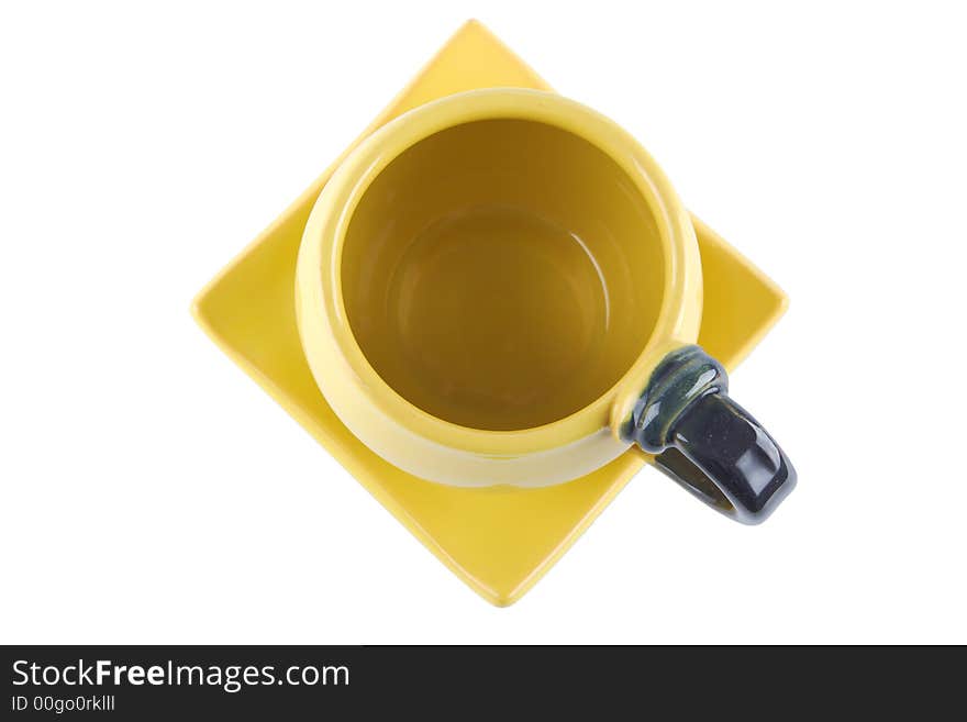 Top view of an empty yellow teacup on square saucer. Top view of an empty yellow teacup on square saucer