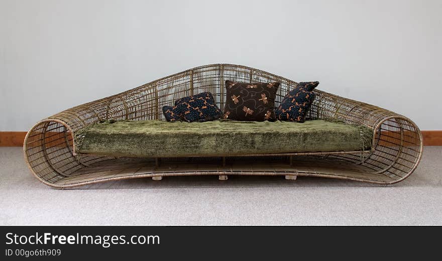 Stylish rattan sofa with pillows