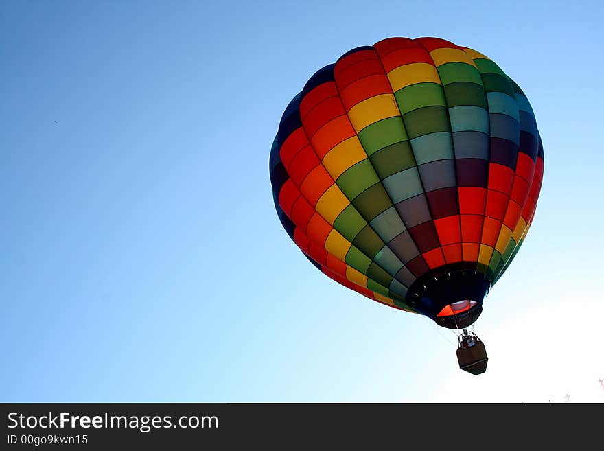 Colorful hot air balloon taking off at dusk. Colorful hot air balloon taking off at dusk