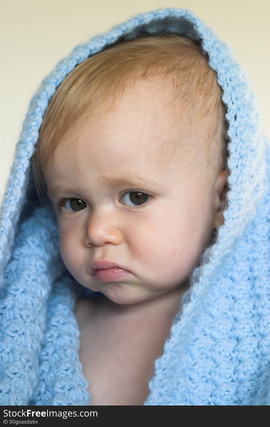 Image of a cute toddler peeking out from under a blanket. Image of a cute toddler peeking out from under a blanket