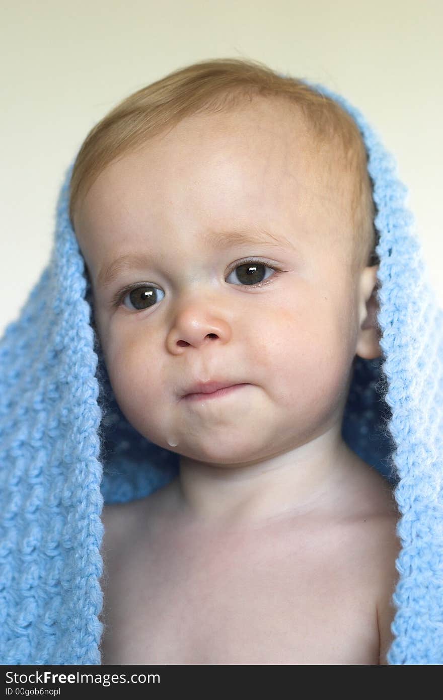 Image of a cute toddler peeking out from under a blanket. Image of a cute toddler peeking out from under a blanket