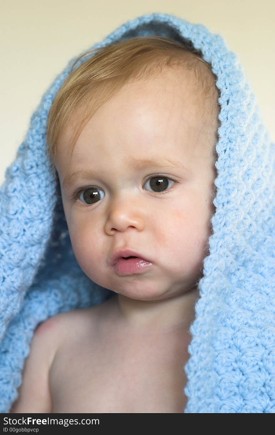 Image of a cute toddler peeking out from under a blanket. Image of a cute toddler peeking out from under a blanket