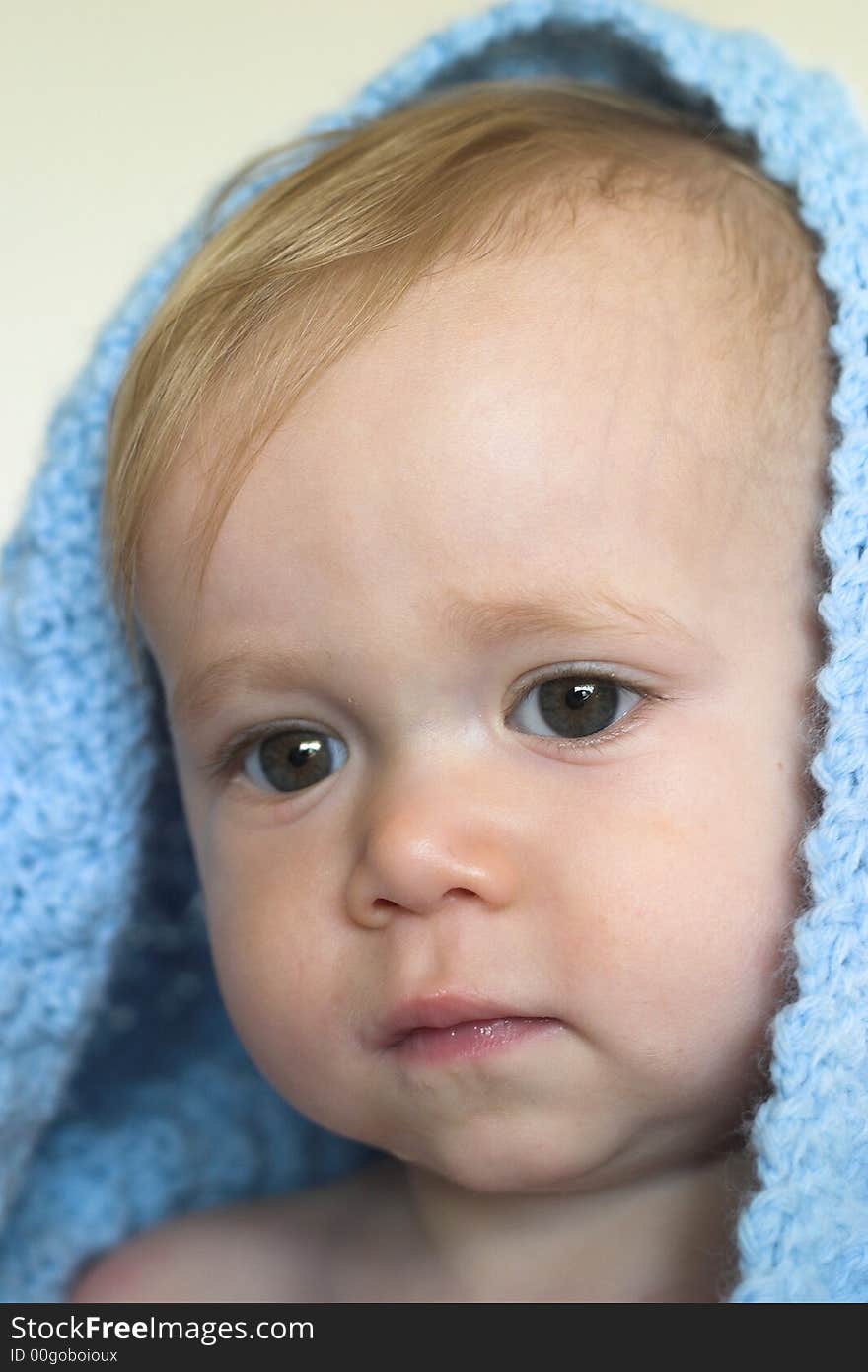 Image of a cute toddler peeking out from under a blanket. Image of a cute toddler peeking out from under a blanket