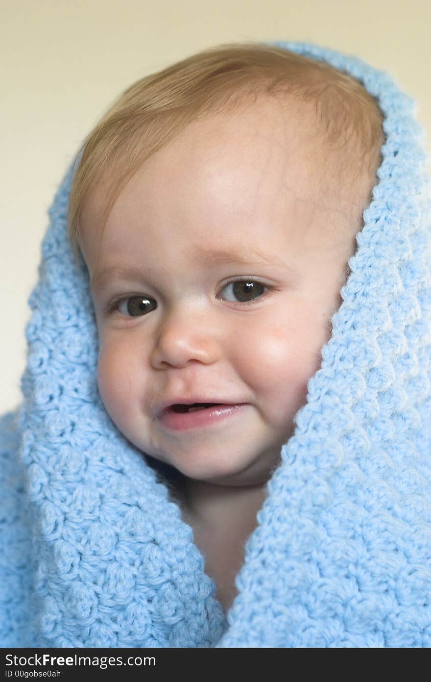 Image of a cute toddler peeking out from under a blanket. Image of a cute toddler peeking out from under a blanket