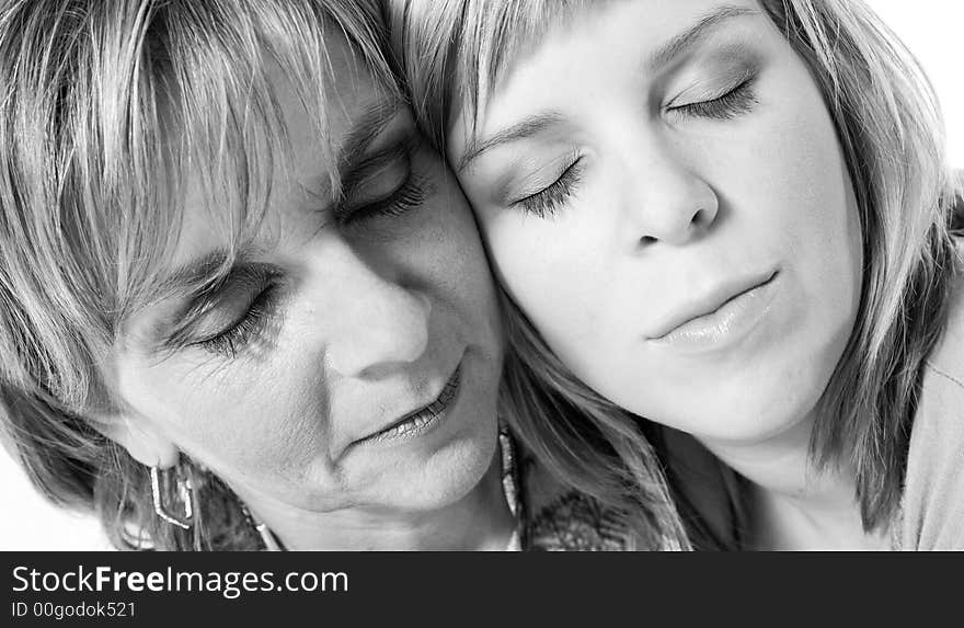 A portrait taken from mother and daughter taken on a white background. A portrait taken from mother and daughter taken on a white background