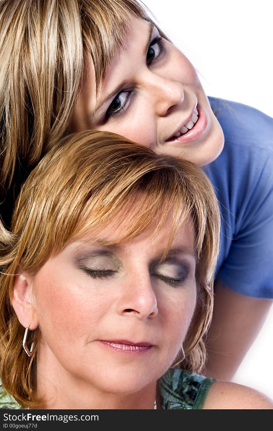 A portrait taken from mother and daughter taken on a white background. A portrait taken from mother and daughter taken on a white background