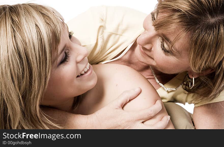 A portrait taken from mother and daughter taken on a white background. A portrait taken from mother and daughter taken on a white background