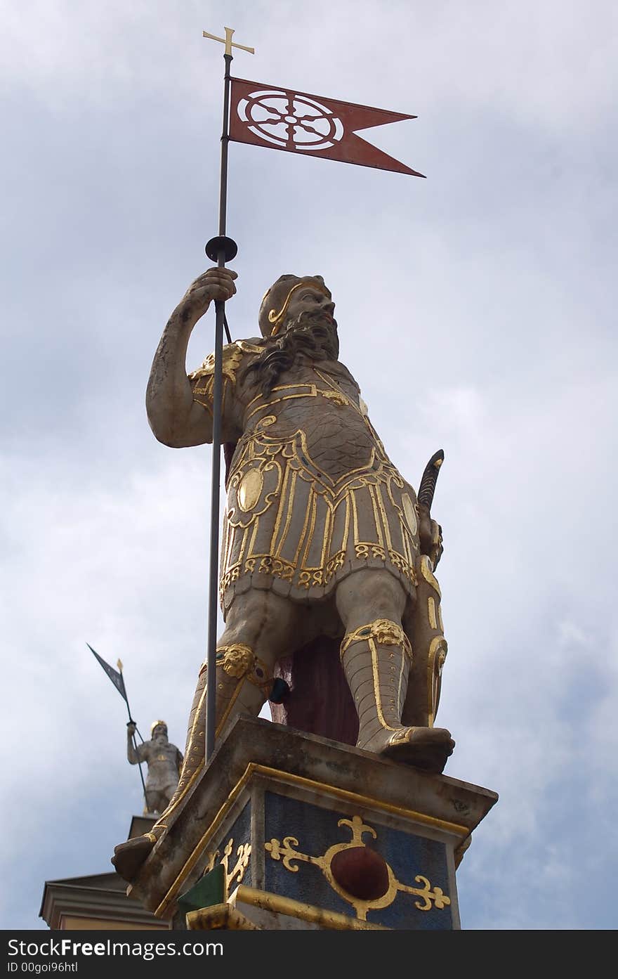 Golden statue on old house