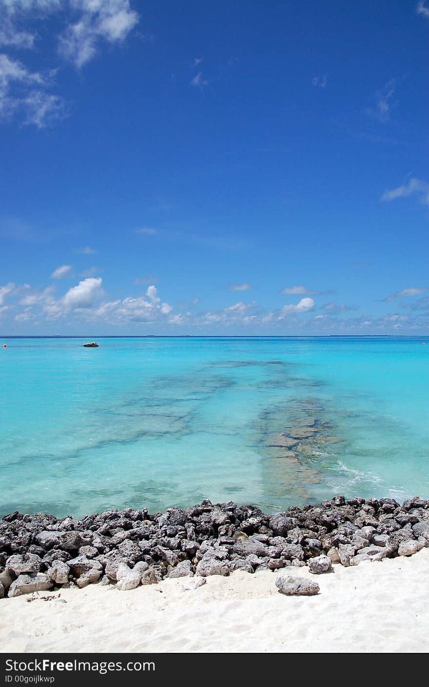 Tropical maldivian beach with rocks and turquoise ocean. Tropical maldivian beach with rocks and turquoise ocean