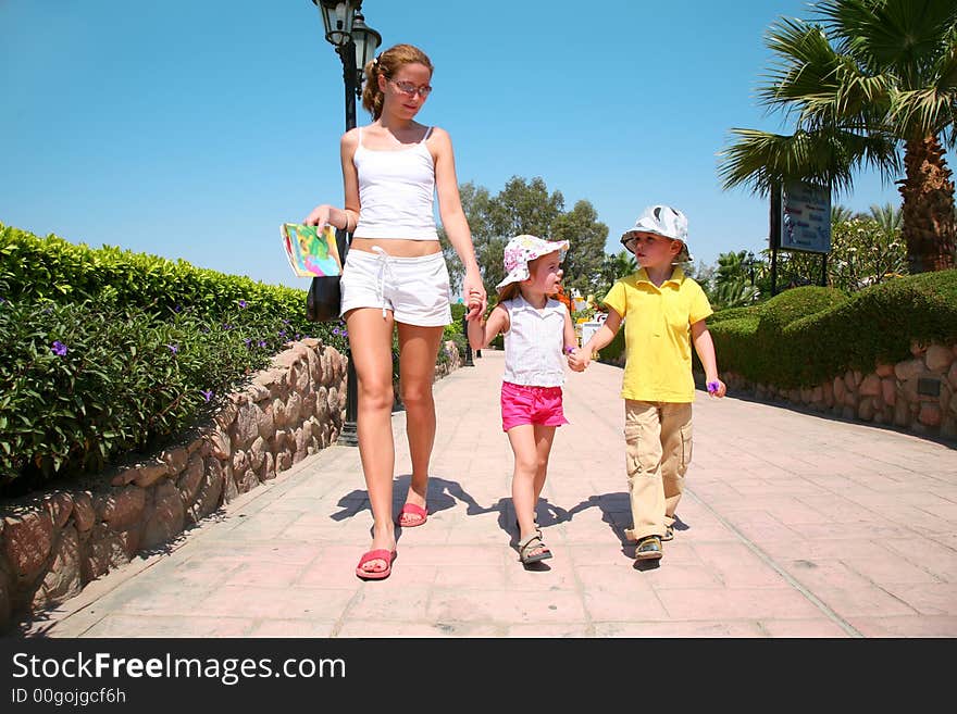 Woman walking with children on resort