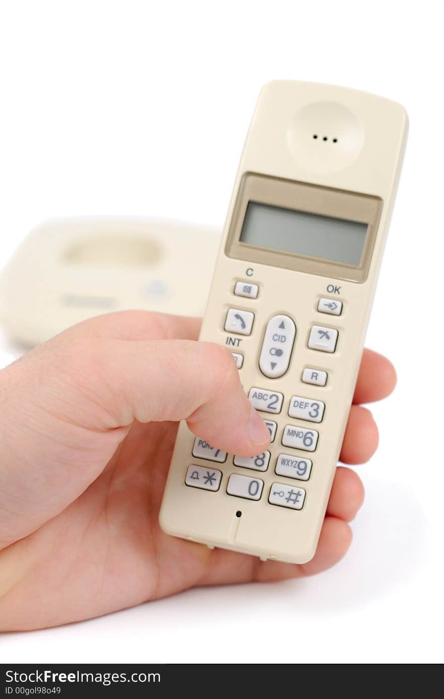 Male hand typing phone number on telephone isolated over white background. Male hand typing phone number on telephone isolated over white background