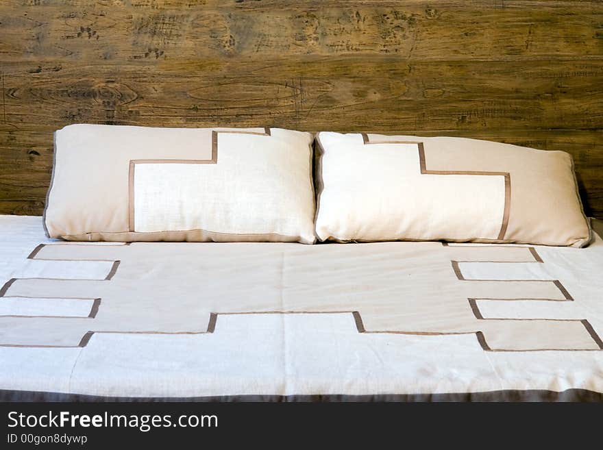 Oold-style wooden bed with pillows