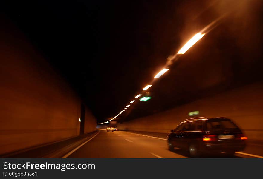 Fast driving throug a tunnel in the night. The picture shows you speed and danger