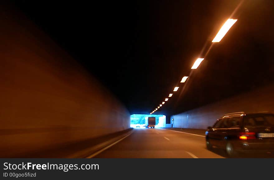 Fast driving throug a tunnel in the night. The picture shows you speed and danger