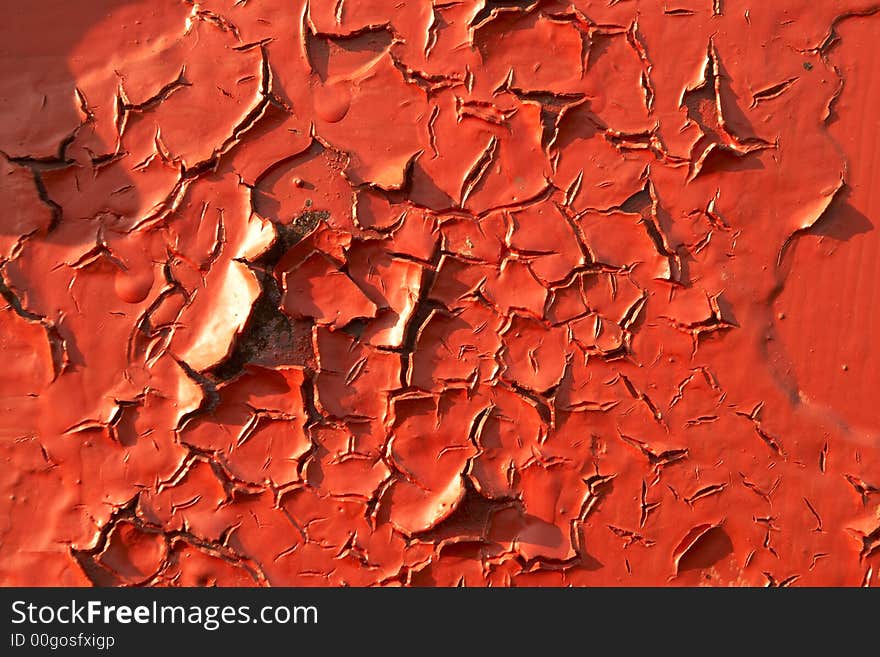 An old layer of red paint. An old layer of red paint.