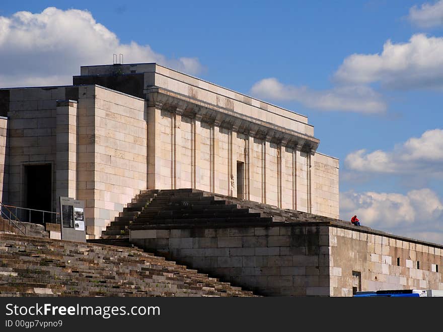 It's the big deployment area tribune from second world war in Nuremberg from Hitler. Now only one man is sitting there. It's the big deployment area tribune from second world war in Nuremberg from Hitler. Now only one man is sitting there