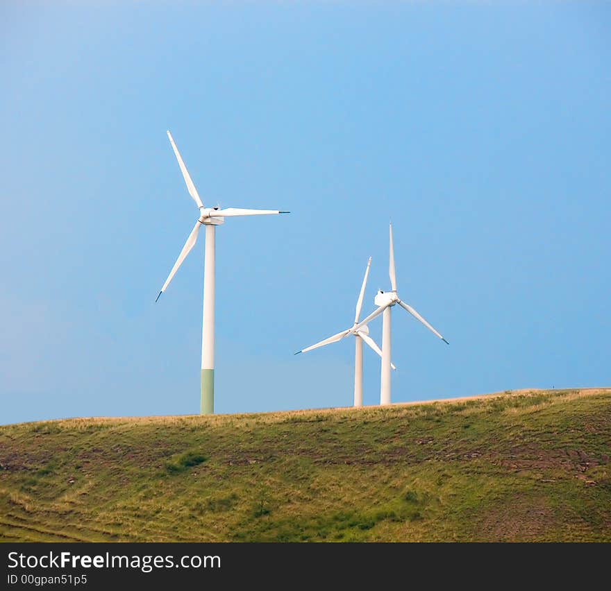 Wind generators of electric energy on a green hill