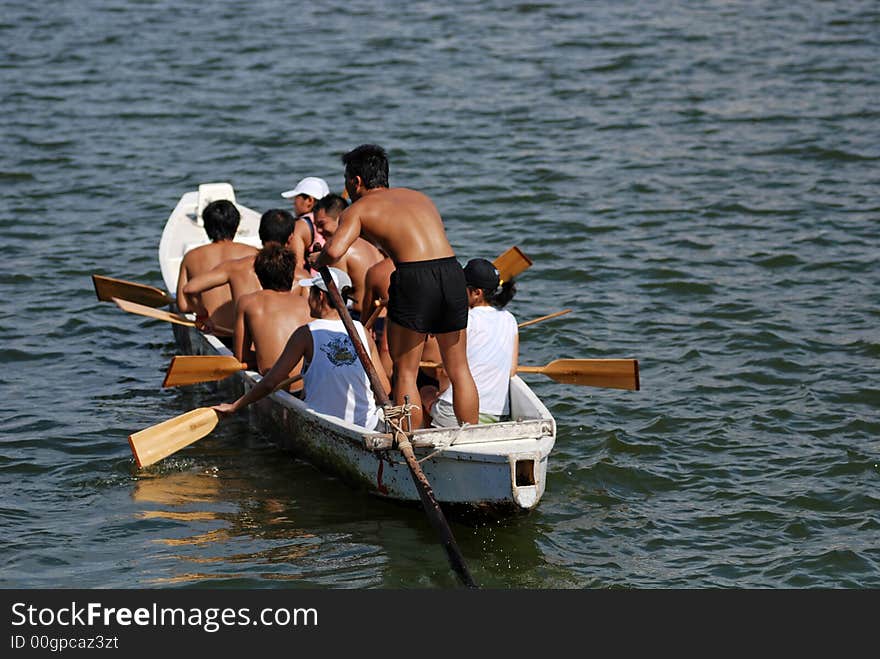 People practicing rowing at the seaside