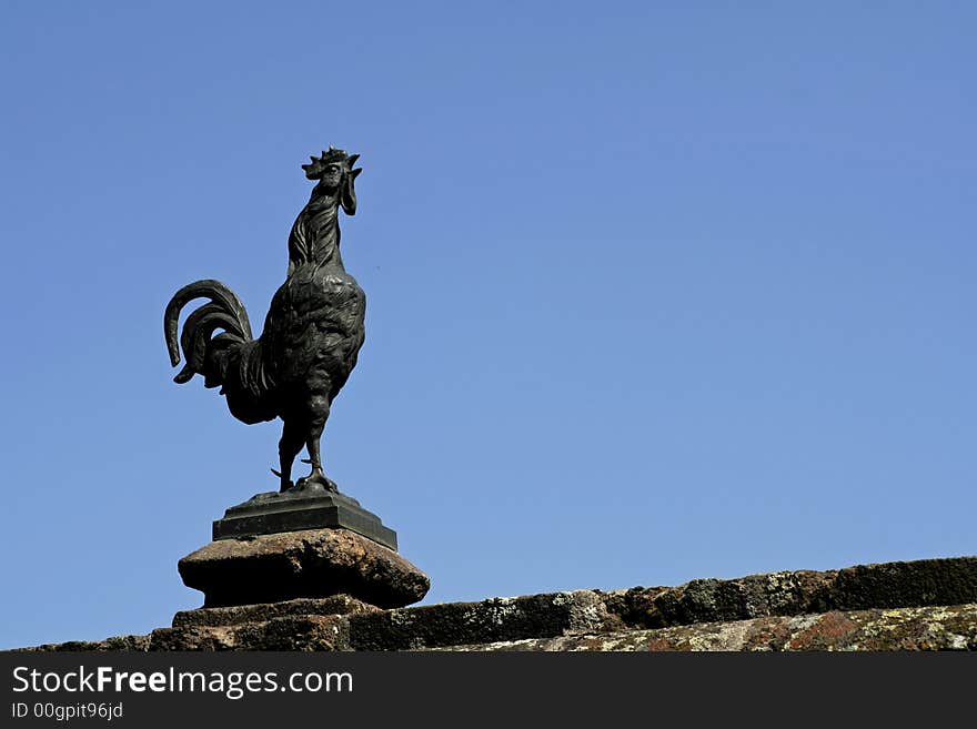 Sculptured cock against sky