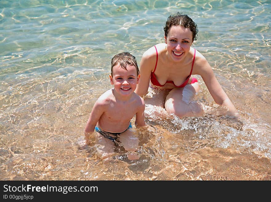 Mother and son in water. Mother and son in water