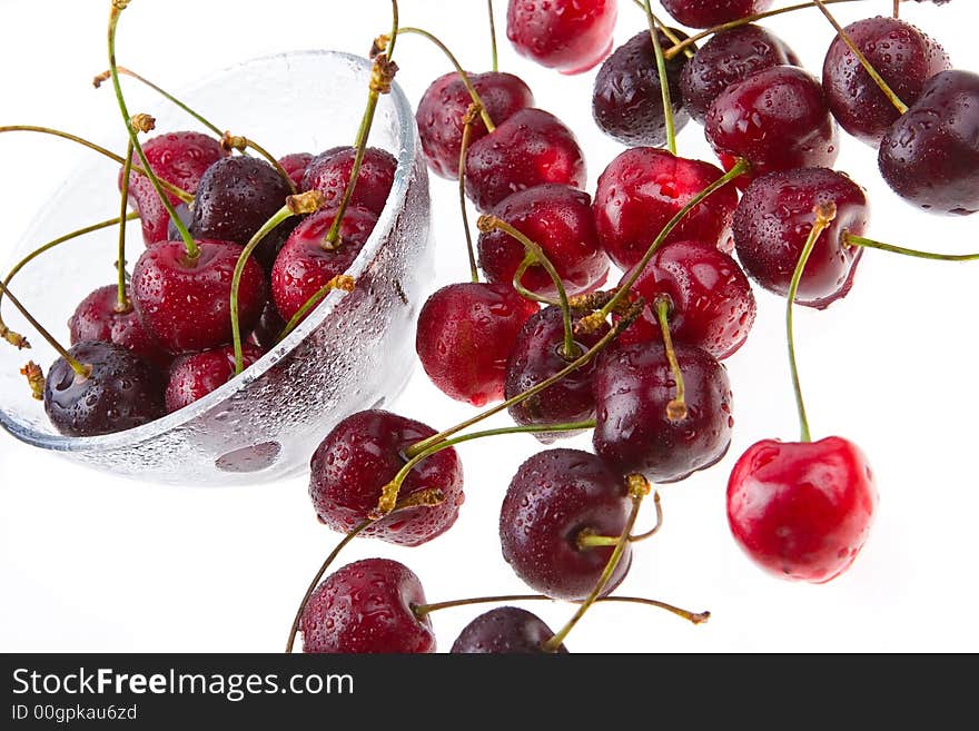 Cooled sweet cherries in drops of waters shined from below