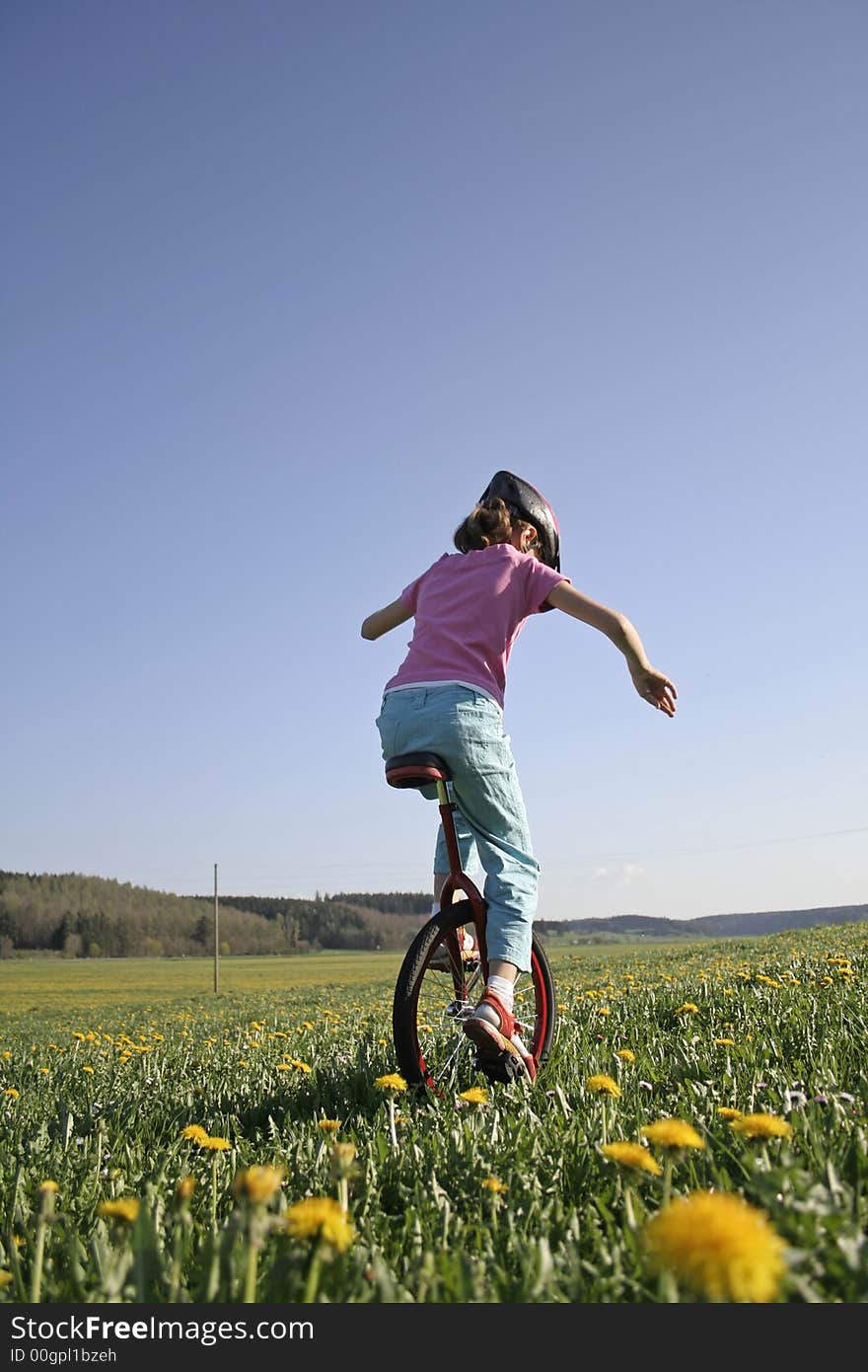 Young girl on monocycle