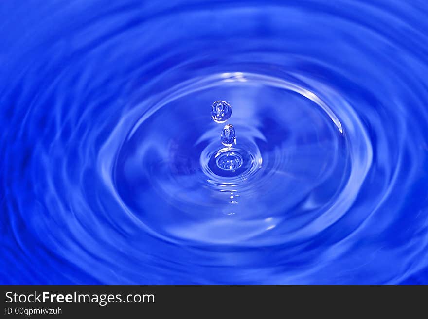 Water drop is falling down and impact with water surface. Water drop is falling down and impact with water surface