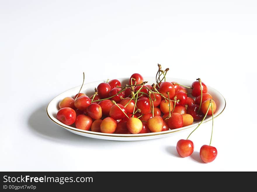 Dish of cherries over white