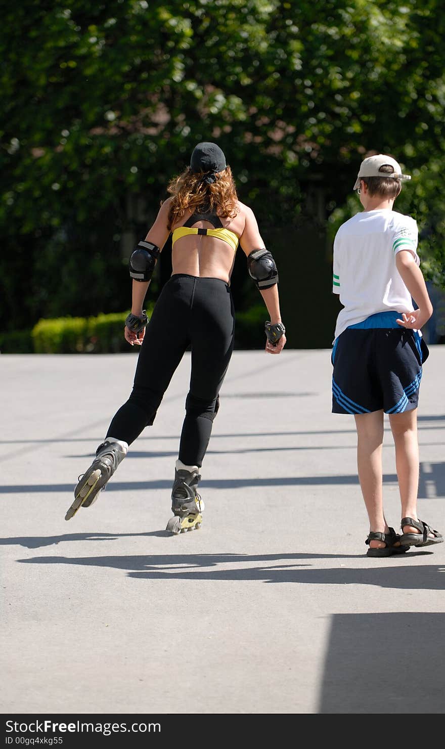 Woman on the roller skates and young boy. Woman on the roller skates and young boy