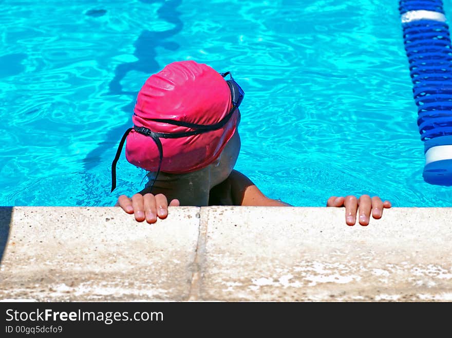 Young girl looking to see what her time was in the 100 yard breast stroke event. Young girl looking to see what her time was in the 100 yard breast stroke event.