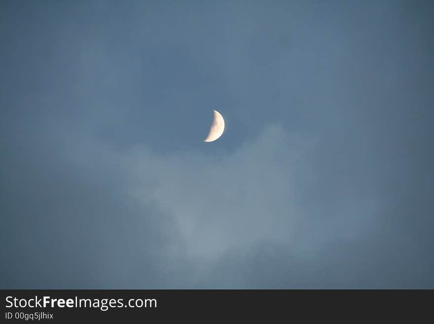 The rainbow colours glowing on the moon against the backdrop of the blue sky. The rainbow colours glowing on the moon against the backdrop of the blue sky